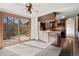 The open kitchen features wood cabinets and laminate countertops, and a sliding glass door at 2949 Vivian St, Wheat Ridge, CO 80215