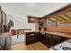 Kitchen with dark wood cabinets, laminate countertop, stainless steel sink, and a small window at 2949 Vivian St, Wheat Ridge, CO 80215