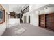 Bright living room featuring a vaulted ceiling, built-in shelving, and staircase with a wood railing at 2949 Vivian St, Wheat Ridge, CO 80215