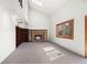 Spacious living room with a brick fireplace, built-in bookshelves, and vaulted ceilings at 2949 Vivian St, Wheat Ridge, CO 80215