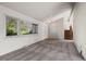 Bright living room featuring large windows, neutral paint, and staircase with carpeted treads at 2949 Vivian St, Wheat Ridge, CO 80215