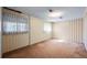 Empty room featuring carpet, wallpapered walls, bright overhead light and dual windows at 2949 Vivian St, Wheat Ridge, CO 80215