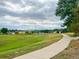 This sidewalk winds through a park offering a scenic view and connecting you to nature and neighborhood amenities at 2949 Vivian St, Wheat Ridge, CO 80215