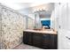 Bathroom with a double sink vanity, large mirror, and a shower with floral curtain at 14803 E 117Th Pl, Brighton, CO 80603