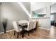 Elegant dining room featuring high ceilings, wood floors, and a stylish table set at 14803 E 117Th Pl, Brighton, CO 80603