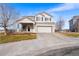 Charming two-story home with a large garage, lovely door, and well-maintained landscaping at 14803 E 117Th Pl, Brighton, CO 80603