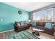 Cozy living room with comfortable seating, decorative rug, and bright natural light at 14803 E 117Th Pl, Brighton, CO 80603