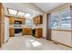 Kitchen with wooden cabinets, white appliances, and a breakfast nook at 7249 S Mount Holy Cross, Littleton, CO 80127