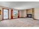 Spacious living room featuring a brick fireplace and scenic views at 7249 S Mount Holy Cross, Littleton, CO 80127