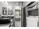 Stylish bathroom featuring dual vessel sinks, laundry area, and access to bedroom at 8055 W Eastman Pl # 104, Lakewood, CO 80227