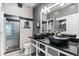 Modern bathroom with dual vessel sinks, large mirror and glass enclosed shower at 8055 W Eastman Pl # 104, Lakewood, CO 80227