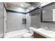 Stylish bathroom with modern fixtures, bathtub and shower, and wood vanity at 8055 W Eastman Pl # 104, Lakewood, CO 80227