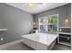 Bright bedroom features large window and unique platform bed with storage at 8055 W Eastman Pl # 104, Lakewood, CO 80227