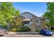 Two-story condo building with stone accents and well-maintained landscaping at 8055 W Eastman Pl # 104, Lakewood, CO 80227