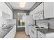 Well-lit kitchen with white appliances, counter space, and a window view at 8055 W Eastman Pl # 104, Lakewood, CO 80227