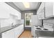 Efficient kitchen layout with white appliances and ample counter space by a window at 8055 W Eastman Pl # 104, Lakewood, CO 80227