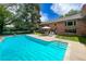 Stunning backyard featuring a large pool, patio area, and lush landscaping perfect for entertaining at 39 Sedgwick Dr, Cherry Hills Village, CO 80113