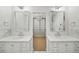 Elegant bathroom with dual vanities, large mirrors, and a walk-in closet with custom shelving at 39 Sedgwick Dr, Cherry Hills Village, CO 80113