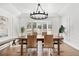 Elegant dining room with tray ceilings, bay window, and stylish chandelier at 39 Sedgwick Dr, Cherry Hills Village, CO 80113
