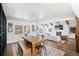 Bright dining area with a rustic wood table, modern chairs, and ample natural light at 39 Sedgwick Dr, Cherry Hills Village, CO 80113