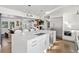 Open kitchen design featuring a large island, stainless steel appliances, and a view into the living area at 39 Sedgwick Dr, Cherry Hills Village, CO 80113