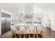 Spacious white kitchen featuring a large island with bar seating and stainless steel appliances at 39 Sedgwick Dr, Cherry Hills Village, CO 80113