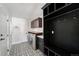 Well-organized laundry room with black and white patterned flooring and built-in storage at 39 Sedgwick Dr, Cherry Hills Village, CO 80113