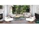 Indoor/outdoor living space with modern chairs, a fireplace, and a view of the trees at 39 Sedgwick Dr, Cherry Hills Village, CO 80113