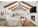 Spacious living room with beamed ceilings, fireplace, and large windows offering natural light at 39 Sedgwick Dr, Cherry Hills Village, CO 80113