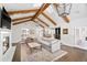 Open-concept living room with fireplace, wood beams, and seamless flow to dining area at 39 Sedgwick Dr, Cherry Hills Village, CO 80113