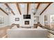 Bright living room featuring wood beams, modern lighting, and cozy fireplace at 39 Sedgwick Dr, Cherry Hills Village, CO 80113