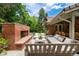 Entertain in style in this outdoor space featuring a brick fireplace and ample seating at 39 Sedgwick Dr, Cherry Hills Village, CO 80113