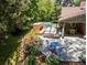 An elevated outdoor space featuring a brick fireplace, multiple seating areas, and a swimming pool at 39 Sedgwick Dr, Cherry Hills Village, CO 80113