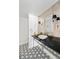 Stylish powder room featuring a marble vessel sink, designer wallpaper, and hexagon-patterned tile floor at 39 Sedgwick Dr, Cherry Hills Village, CO 80113