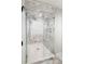 Luxurious shower featuring marble walls, dual shower heads, glass door, and built-in bench at 39 Sedgwick Dr, Cherry Hills Village, CO 80113