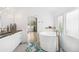 Bright bathroom featuring a soaking tub, tile floors, and a vanity with dual sinks at 421 Saint Paul St, Denver, CO 80206