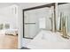 Modern bathroom with white subway tile shower, sleek fixtures, and a glimpse of a bedroom at 421 Saint Paul St, Denver, CO 80206