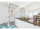 Bright bathroom featuring patterned tile floors, a glass shower, and a white vanity with dual sinks at 421 Saint Paul St, Denver, CO 80206