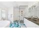 Bright bathroom featuring patterned tile floors, a glass shower, and a soaking tub near a window at 421 Saint Paul St, Denver, CO 80206