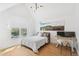 Bright bedroom featuring hardwood floors, a white bed, and a built-in desk at 421 Saint Paul St, Denver, CO 80206