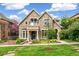 Charming stone-clad home with manicured lawn, beautiful landscaping and a welcoming entrance at 421 Saint Paul St, Denver, CO 80206