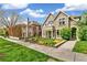 Beautiful stone house with a well-manicured front yard and lush landscaping at 421 Saint Paul St, Denver, CO 80206