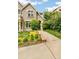 Lovely stone home featuring lush landscaping, a verdant lawn, and a inviting walkway at 421 Saint Paul St, Denver, CO 80206