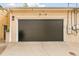 View of a two car garage with a black garage door and some security cameras at 421 Saint Paul St, Denver, CO 80206
