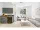 Cozy sitting area featuring a kitchenette, gray sofa, and natural light from the window at 421 Saint Paul St, Denver, CO 80206