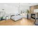 Bright main bedroom featuring hardwood floors, a stone fireplace and large windows with outside views at 421 Saint Paul St, Denver, CO 80206