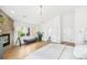 Spacious main bedroom featuring hardwood floors, a fireplace, and a bench seat under the large windows at 421 Saint Paul St, Denver, CO 80206