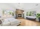 Light-filled main bedroom showcasing a stone fireplace, hardwood floors and large windows at 421 Saint Paul St, Denver, CO 80206