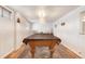 Spacious basement with a large pool table, classic paneled walls, and plenty of room for entertainment at 10520 W 101St Pl, Westminster, CO 80021