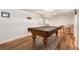 Basement entertainment area with a stunning pool table and classic paneled walls at 10520 W 101St Pl, Westminster, CO 80021